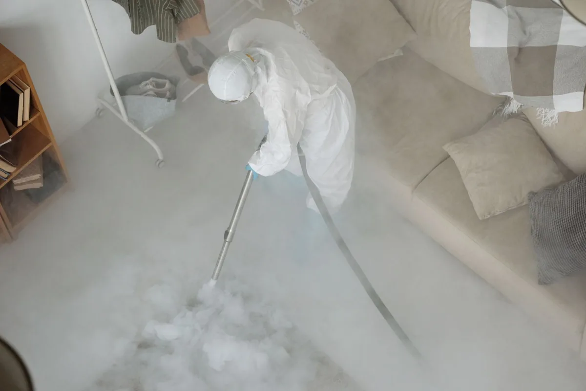 Biohazard cleanup technician in protective equipment, Bolivar Peninsula, TX